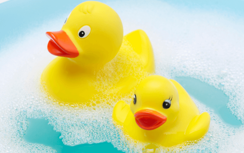 Rubber ducks in a bath with water problems to be fixed by drain engineers or plumbers