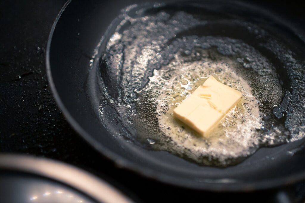 butter in a frying pan - prolonged exposure to hot water, fats, oils, and grease can cause Drain Delamination
