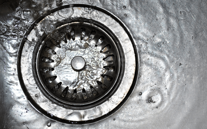 A clean kitchen sink with a strainer to support eco friendly drain maintenance